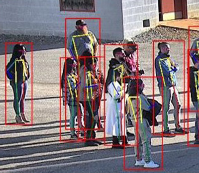 Screenshot of people standing around with computer identifying individual people